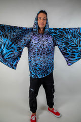 Model displaying the full length of the Chromium Festival Scarf, emphasizing its oversized fit and vibrant holographic pattern.