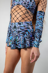 Close-up angle of the Chromium Micro Skater Skirt, emphasizing its lightweight, flared silhouette and cyber aesthetic.