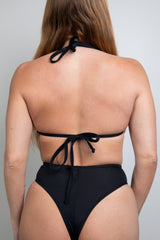 Back view of a woman wearing a black triangle bikini top with tie straps, perfect for rave outfits.