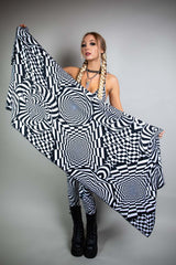 A woman holding up a black and white geometric printed pashmina.