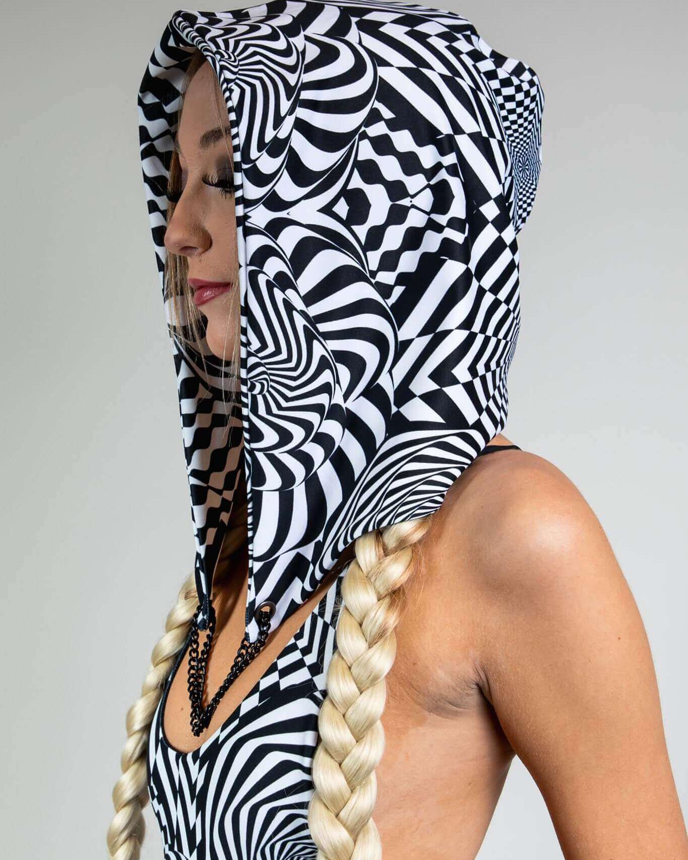 Distortion Assassin Hood featuring an abstract optical design, perfect for rave outfits and dance events.