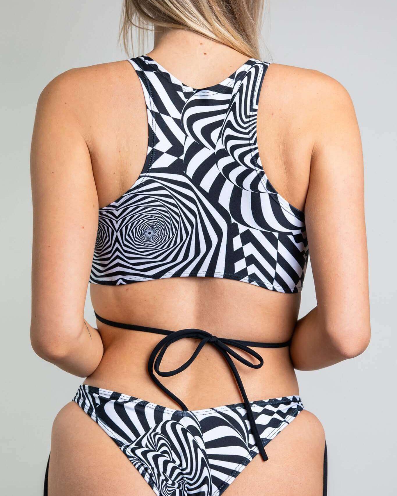 Rave outfit featuring a Distortion Teaser Top with abstract black and white patterns and a crisscross strap design.