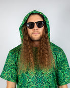 Model wearing a green Dominion Assassin Hood and sunglasses, showcasing a vibrant rave outfit.