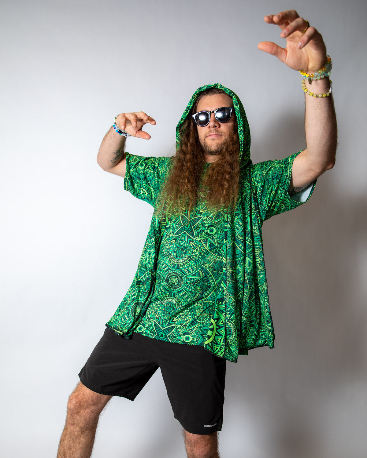Model in green rave hood with sunglasses striking a pose, perfect for festival vibes and creativity.