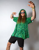 Model in green rave hood with sunglasses striking a pose, perfect for festival vibes and creativity.