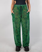 Dominion Mesh Lucy Pants in neon green tribal print, featuring pockets and a wide leg for rave style.