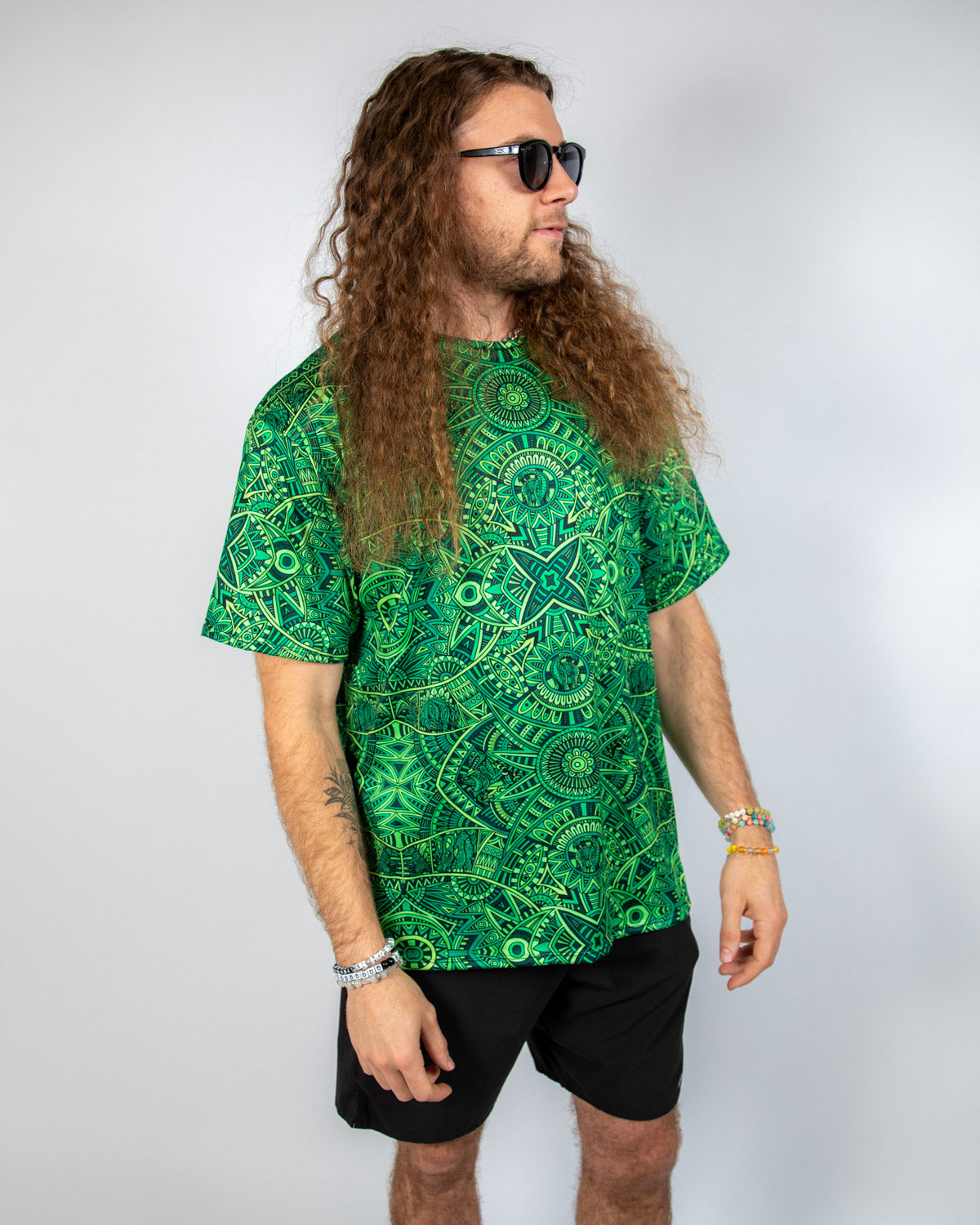 Dominion Oversized Softee rave t-shirt featuring bold green psychedelic pattern and relaxed fit style.