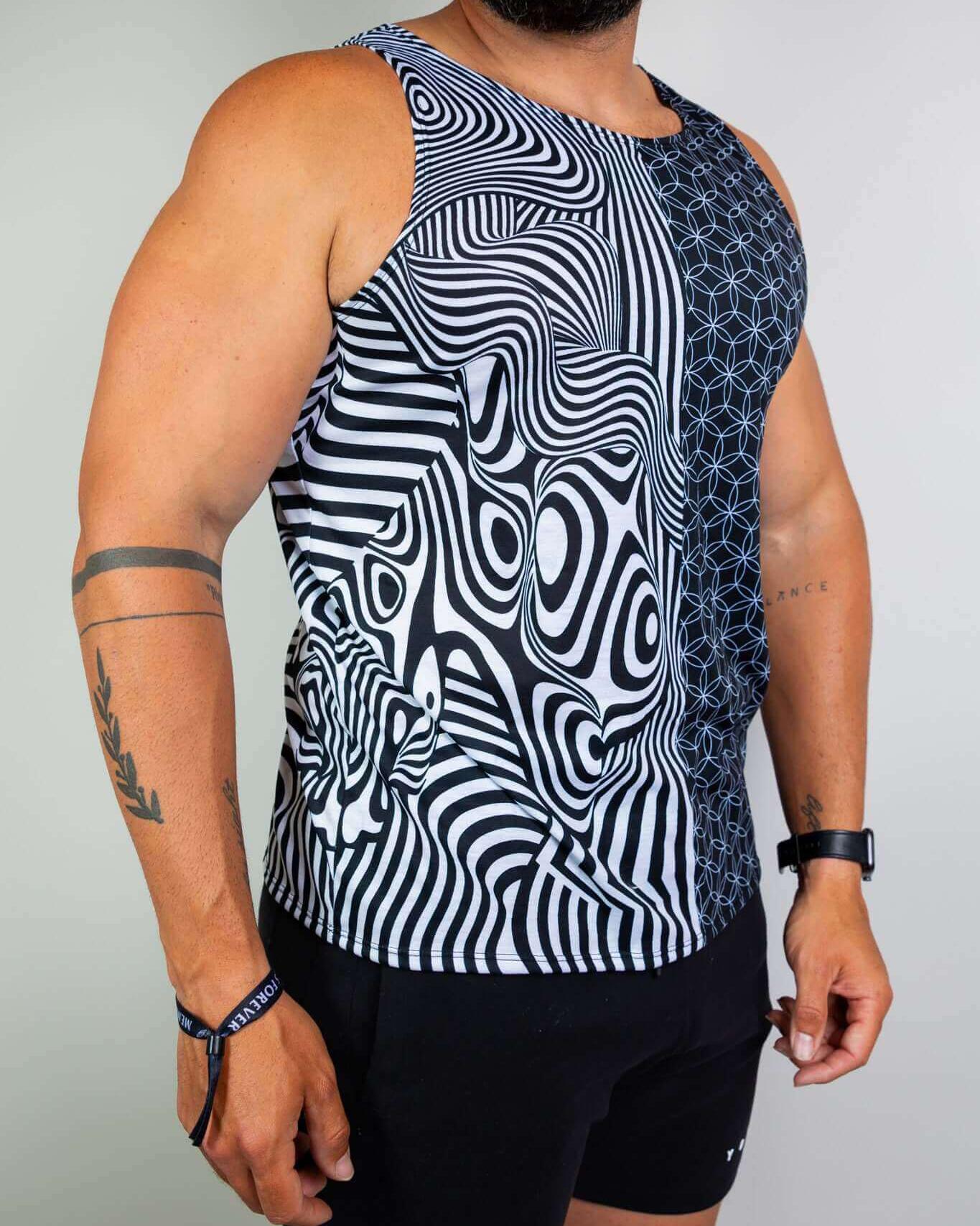 Man wearing Duality Unisex Tank Top with black and white graphic design, perfect for rave outfits and stylish events.