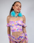 Woman wearing Duckies Bardot Top, a vibrant off-shoulder rave outfit in purple, yellow, and pink colors.