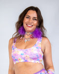Model wearing the Duckies Classic Top, a vibrant cropped rave outfit featuring purple, yellow, and pink colors.