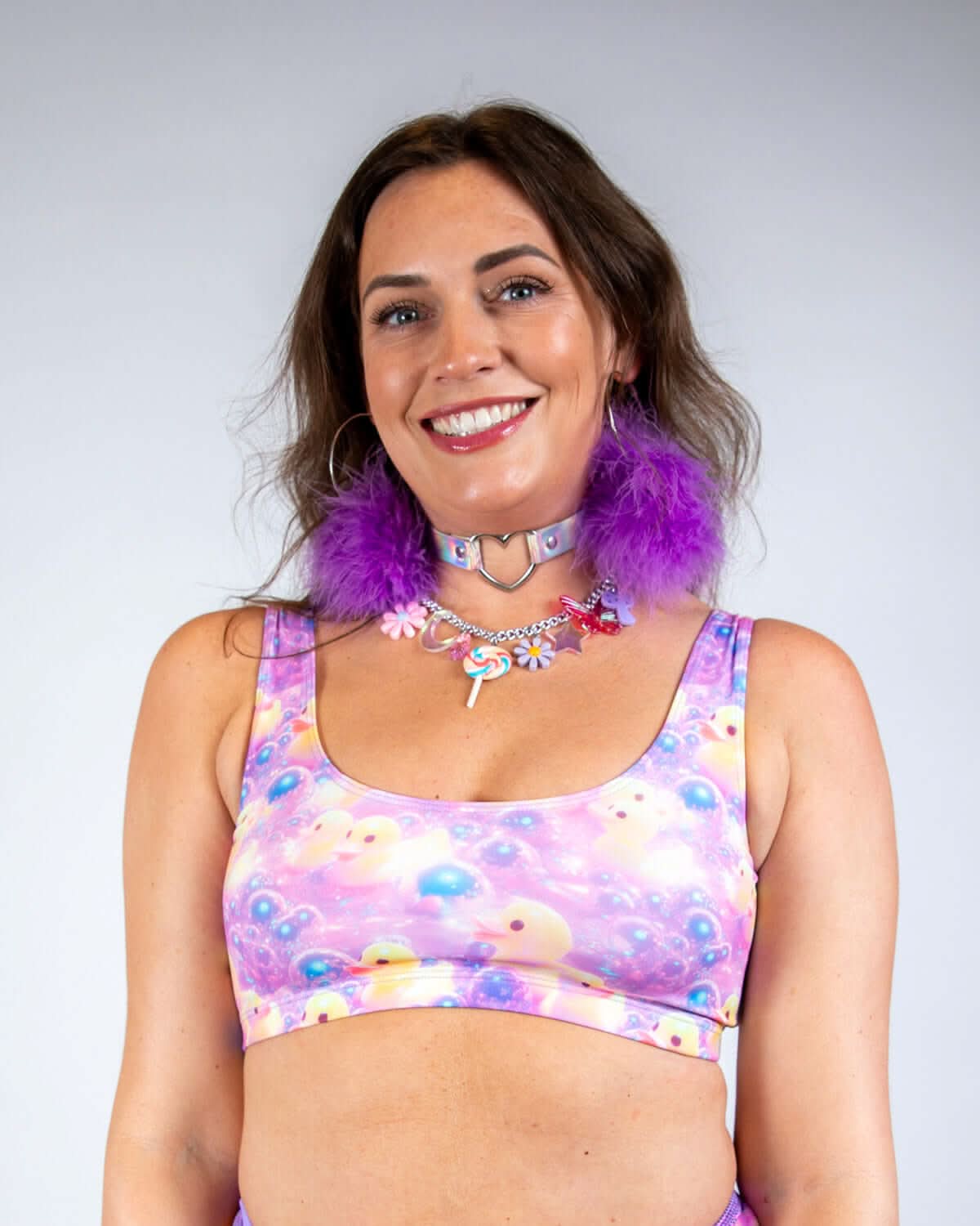 A woman wearing the Duckies Classic Top, a vibrant cropped top perfect for rave outfits, showcasing a colorful design.