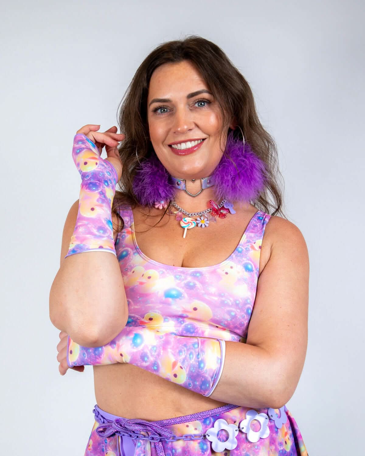 Model wearing Duckies Gloves with vibrant purple, yellow, and pink print, showcasing rave outfits style and festival vibes.