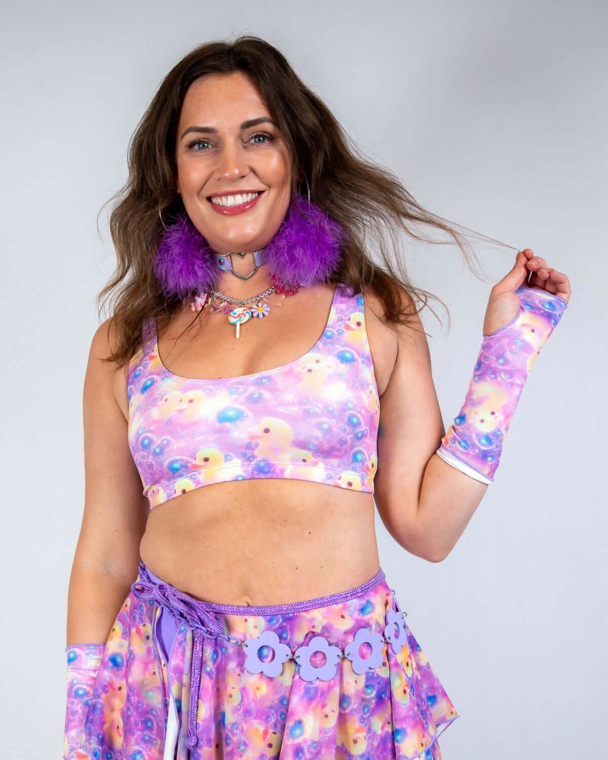 Woman wearing Duckies Gloves with rave outfit featuring colorful prints and accessories, perfect for festival dancing.