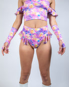 Model wearing Duckies High Waisted Thong with Ruffles in vibrant purple, yellow, and pink, perfect for rave outfits.