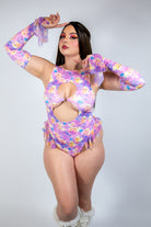 A model wearing Duckies Spellcaster Arm Sleeves with a vibrant floral design, perfect for rave outfits.