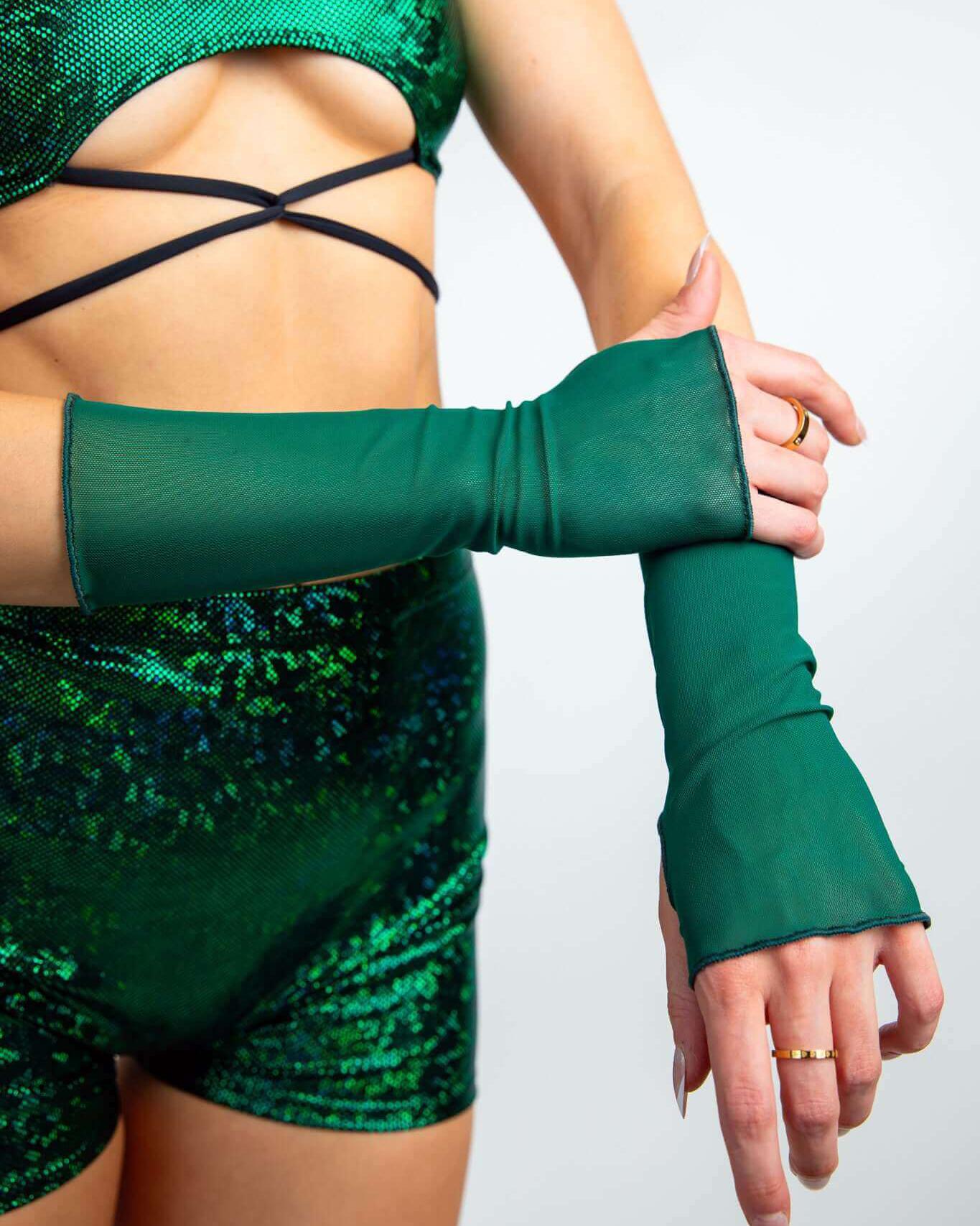 Emerald mesh gloves worn with a shiny green rave outfit featuring thumb holes and a stylish arm design.