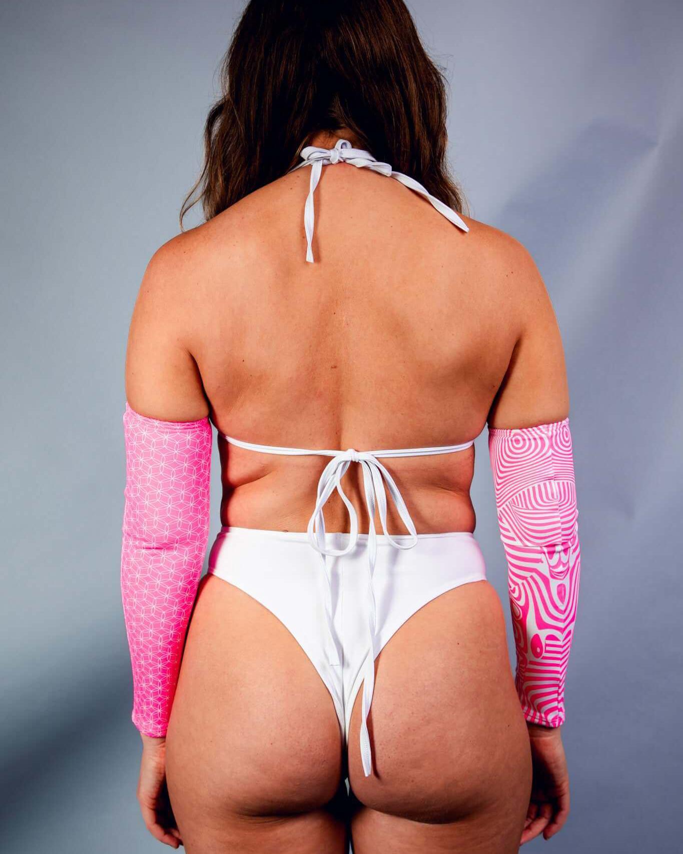 Woman modeling back view of Electricity Wrap Bikini Top with pink animated sleeves, perfect for rave outfits.