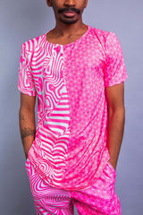 A man wearing a pink and white t shirt and matching pants/
