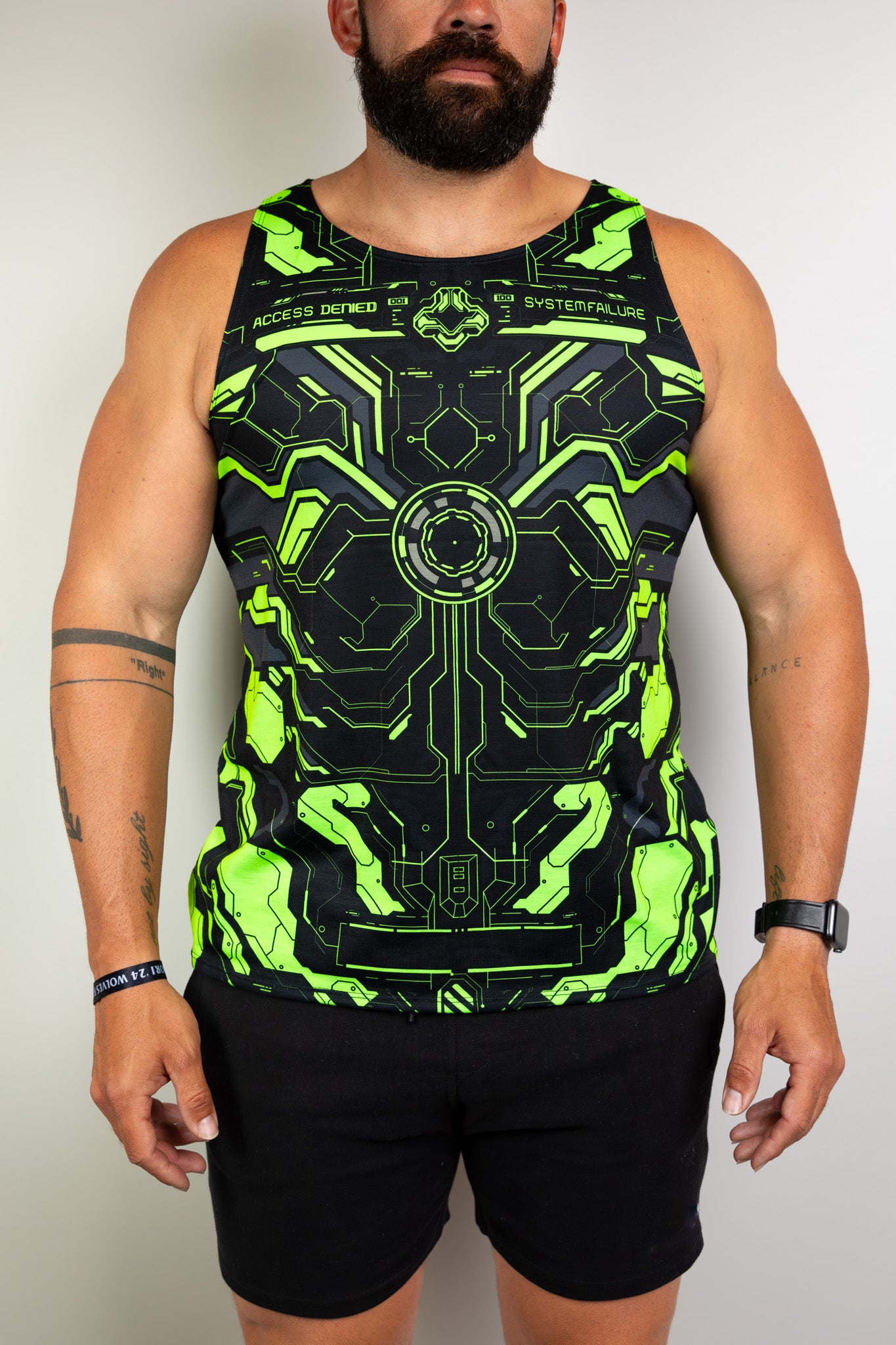 Model wearing a neon green and black tech-themed tank top, perfect for raves. Freedom Rave Wear offers unique festival fashion. 