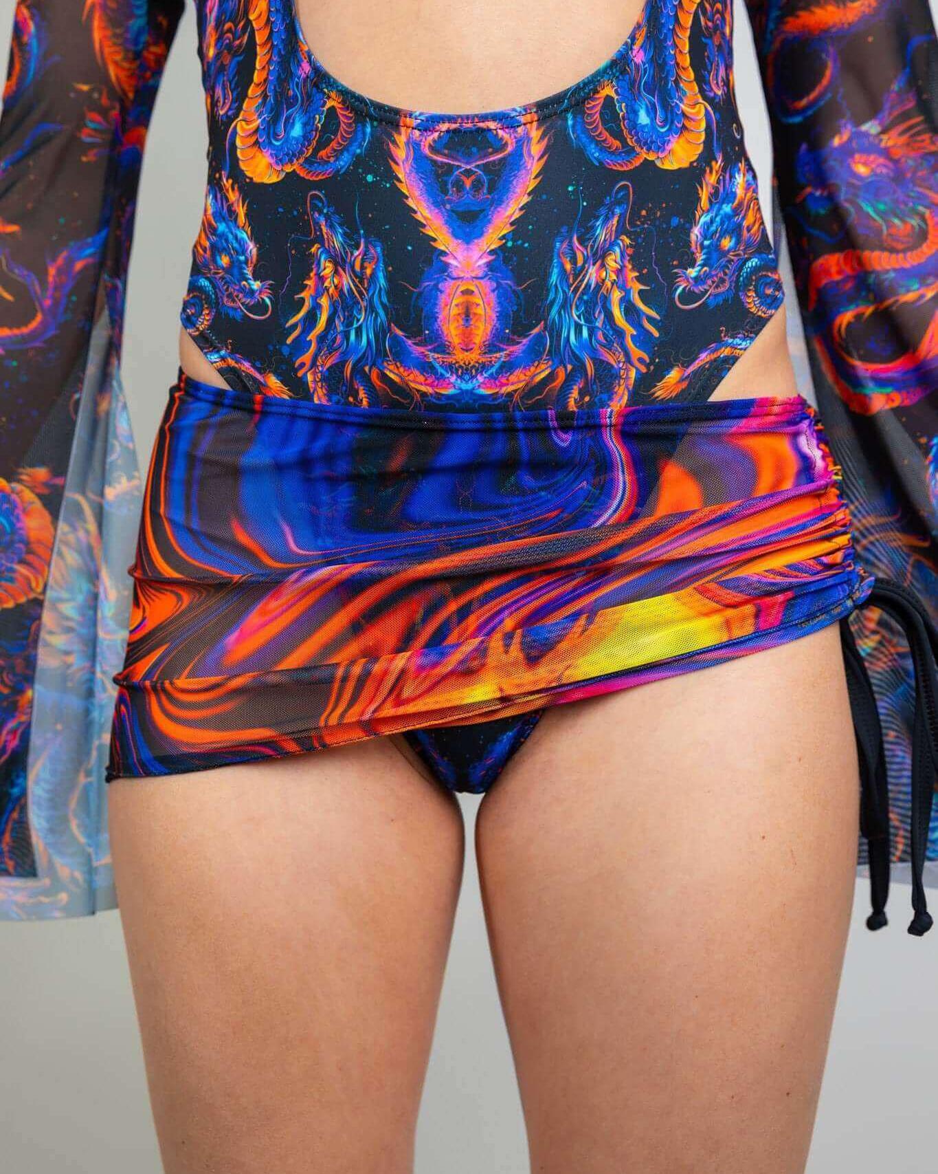 Embers Mesh Cinch Skirt styled with a vibrant bodysuit, showcasing adjustable lengths for trendy rave outfits.