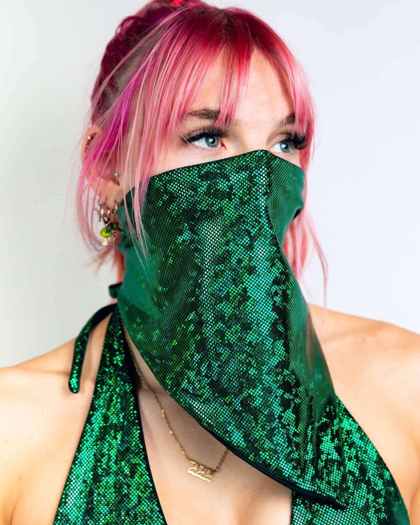 Woman wearing an emerald holo bandana styled as a face mask, adding a pop of color to her outfit for rave events.