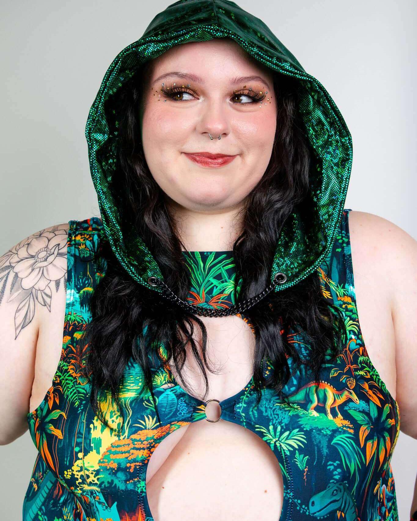 Model wearing the Emerald Holo Assassin Hood with vibrant floral outfit, perfect for rave outfits and festival fashion.