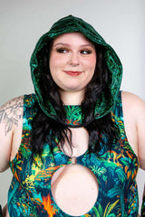 Model wearing the Emerald Holo Assassin Hood with vibrant floral outfit, perfect for rave outfits and festival fashion.