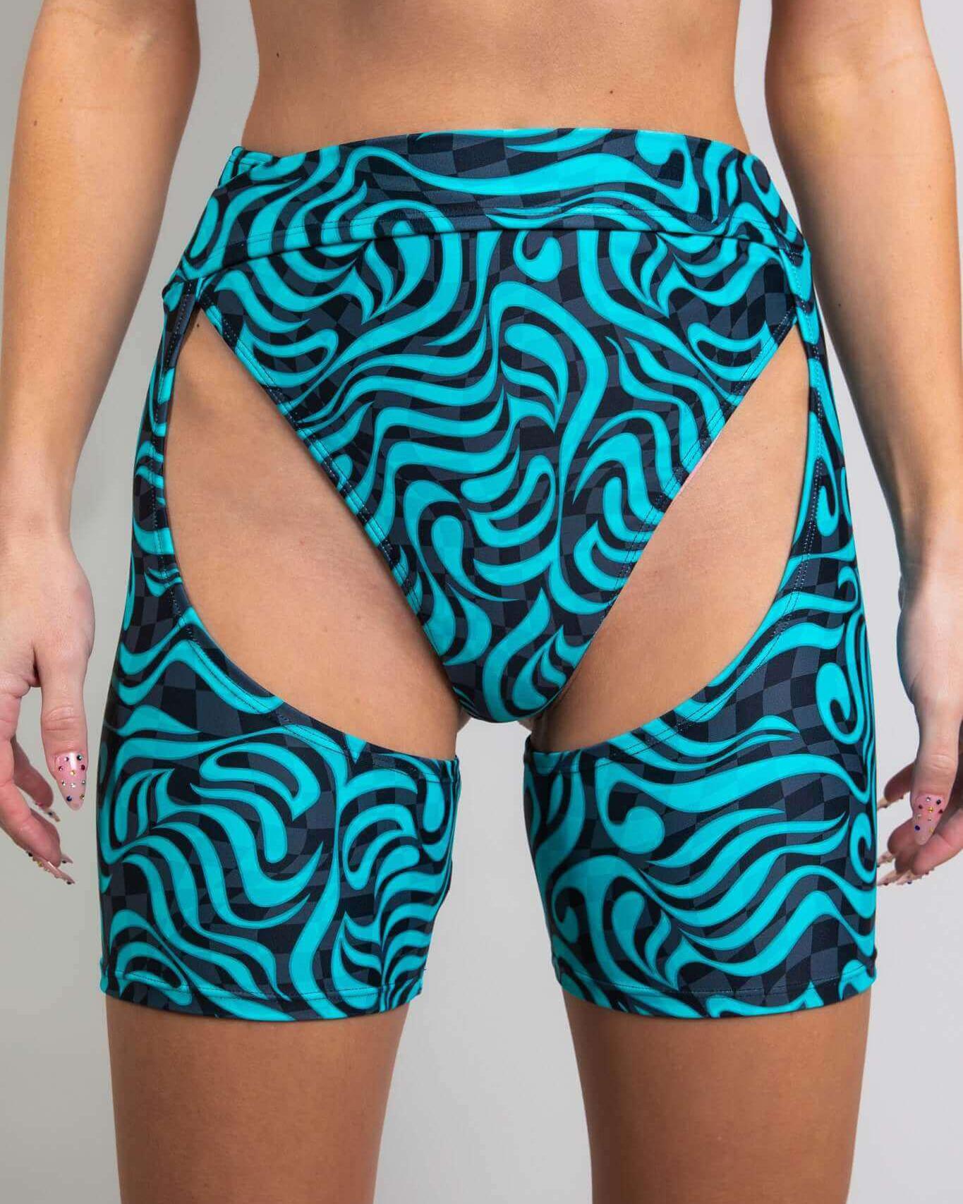 Enigma Chaps featuring a high waist, cutout design, and vibrant swirl pattern, perfect for stylish rave outfits.