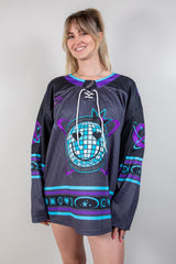 Woman modeling the Freedom Fam limited edition hockey jersey, featuring bold colors and rave-themed designs.