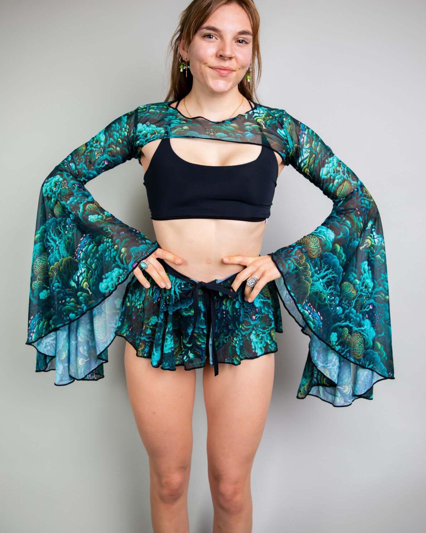 Model showcasing Faewood Mesh Bell Sleeves paired with a black crop top and matching shorts for a rave outfit.