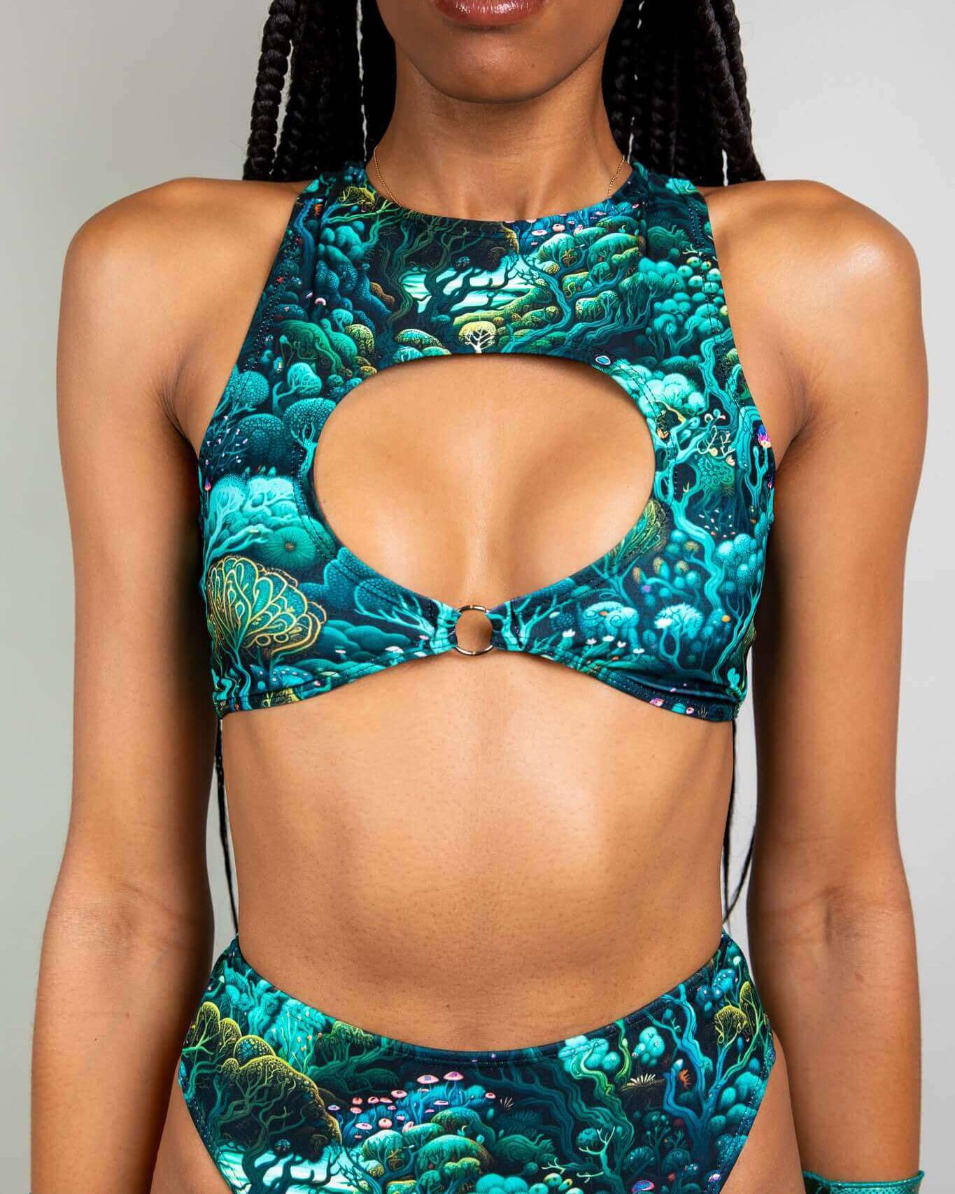 Model wearing Faewood Keyhole Top with O-ring detail, showcasing vibrant forest print, perfect for rave outfits.