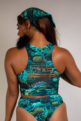 Faewood Slit Crop Top with green and blue forest print, back view highlighting racerback style and seamless fit, paired with matching bottoms.