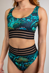 Faewood Sporty Top with green and blue forest print, side-front view highlighting scoop neckline and mesh band underbust.