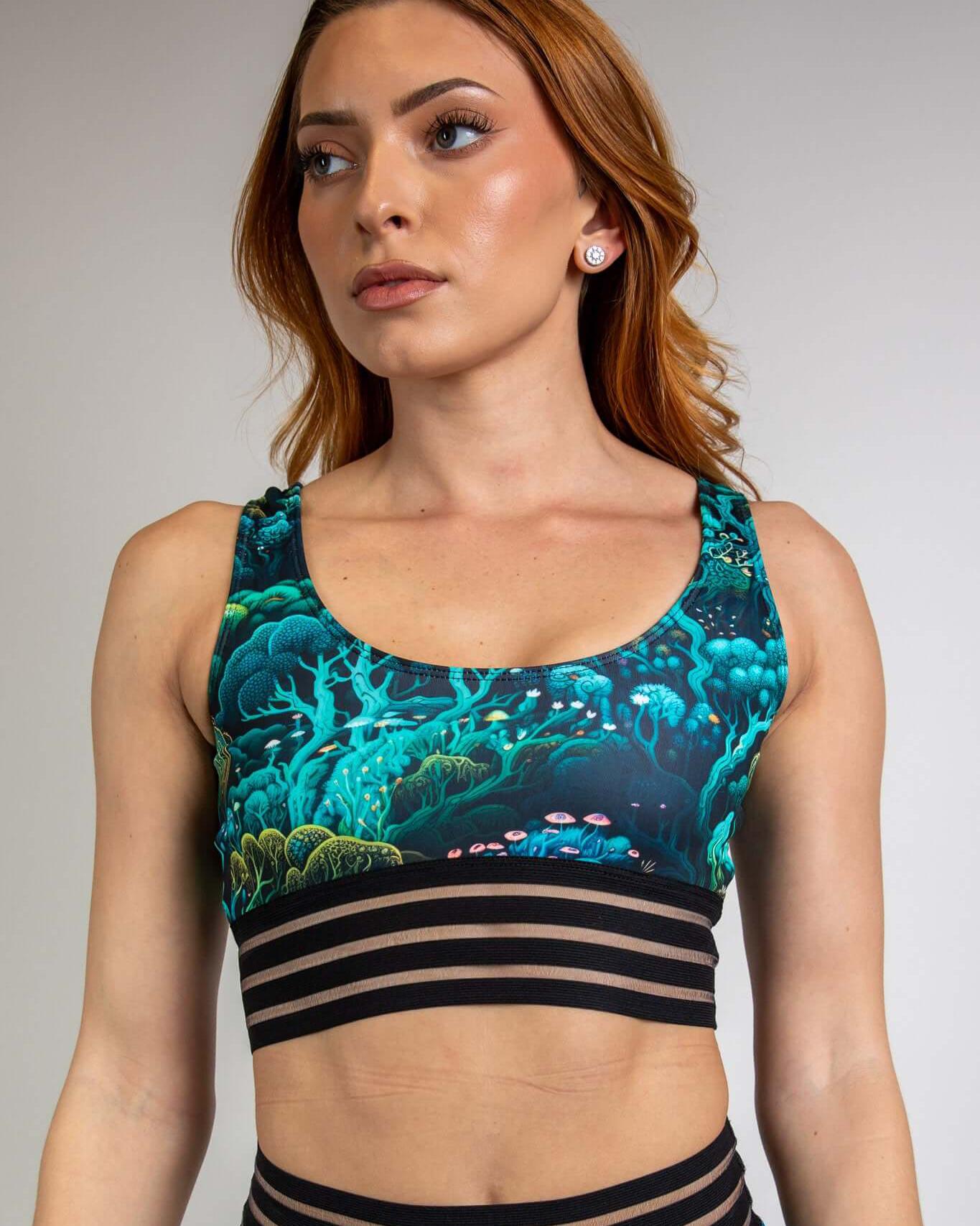 Woman wearing the Faewood Sporty Top, featuring forest-themed design and supportive wide elastic band, ideal for rave outfits.