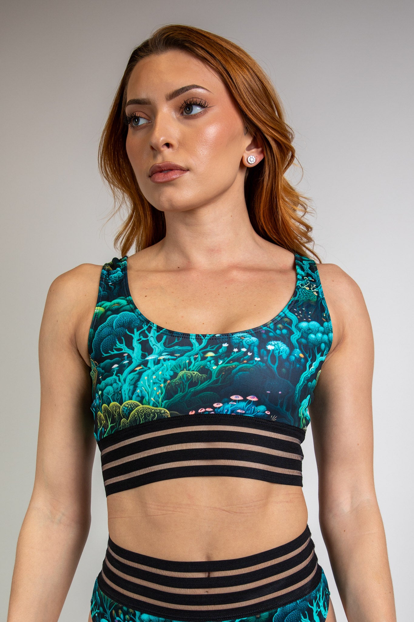 Faewood Sporty Top in green and blue forest print, front view showcasing scoop neckline, fitted design, and mesh underbust band.