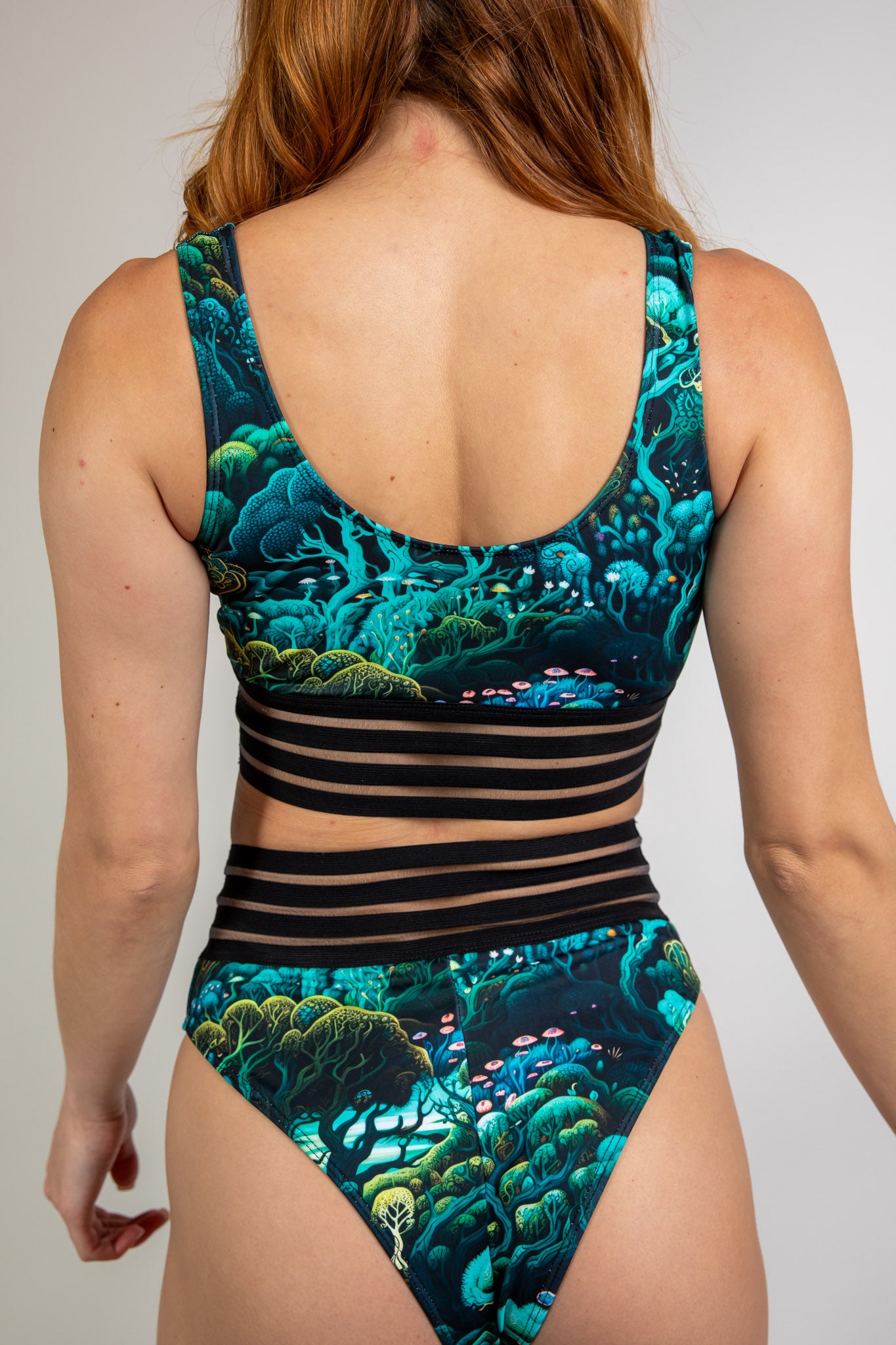 Faewood Sporty Top in green and blue forest print, back view highlighting racerback design, mesh underbust band, and seamless fit.