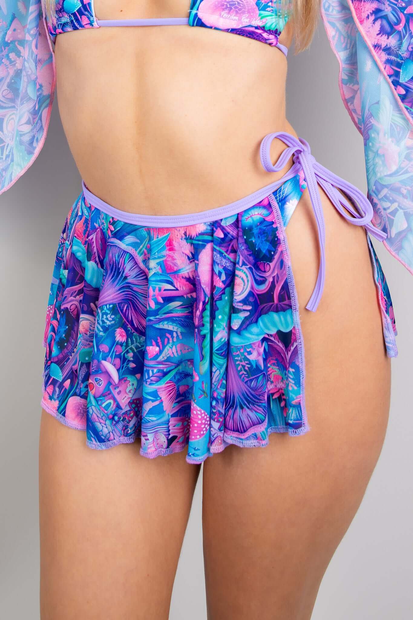 Close-up of Freedom Rave Wear's Fairycore skirt, featuring vibrant purple, blue, and pink psychedelic patterns with side-tie.