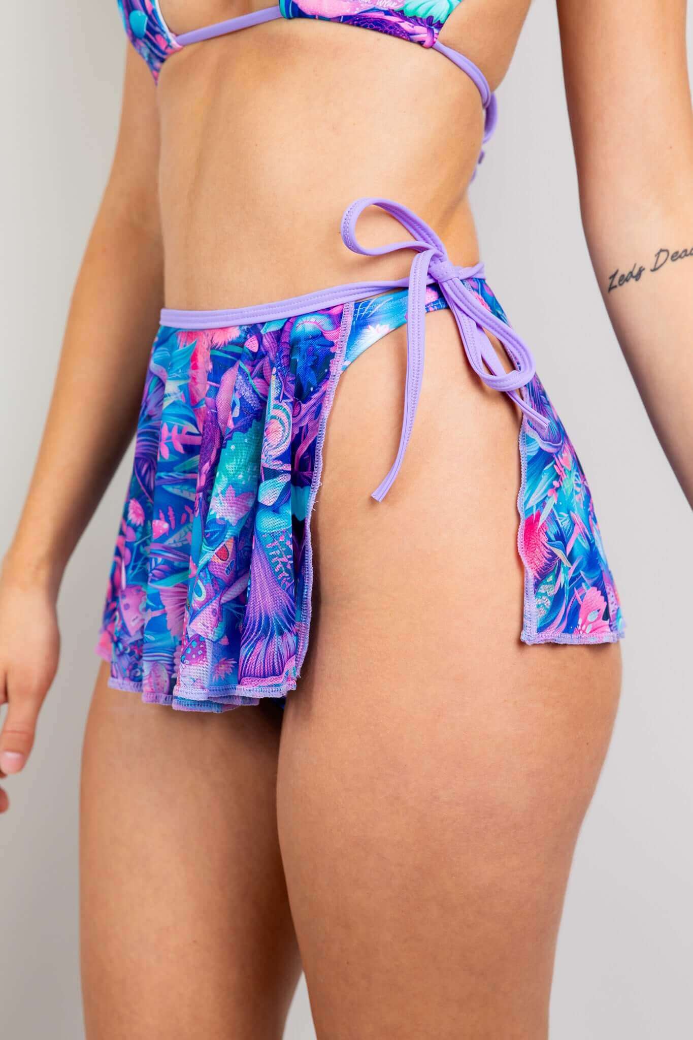 Close-up of Freedom Rave Wear's Fairycore skirt, featuring vibrant purple, blue, and pink psychedelic patterns with side-tie.