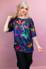 Front view of a Freedom Rave Wear oversized tee featuring a vibrant, mystical design with butterflies and a nature-inspired fantasy scene.