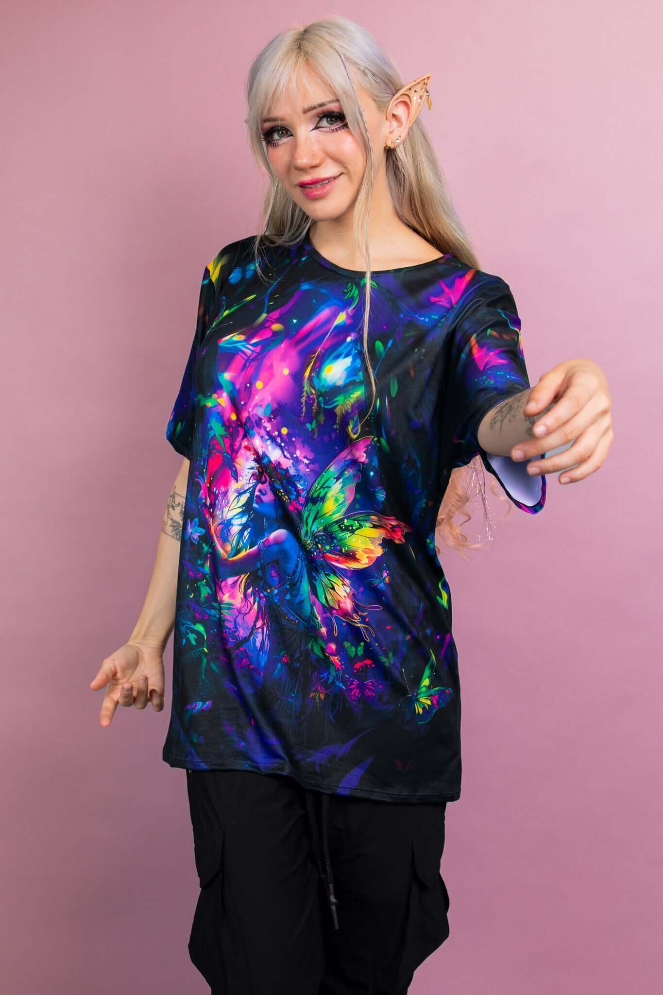 Front view of a Freedom Rave Wear oversized tee, featuring a vibrant, neon-colored fairy with butterfly wings on a black background.