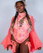 Colorful pink floral swimsuit with flared sleeves, perfect for summer beachwear and vibrant summer vibes.