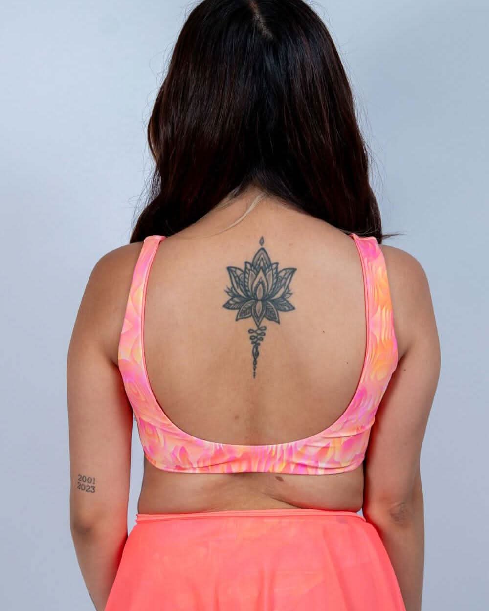 Back view of a woman in a pink Fire Drift Bikini Top, showcasing its thick straps and molten swirl print.