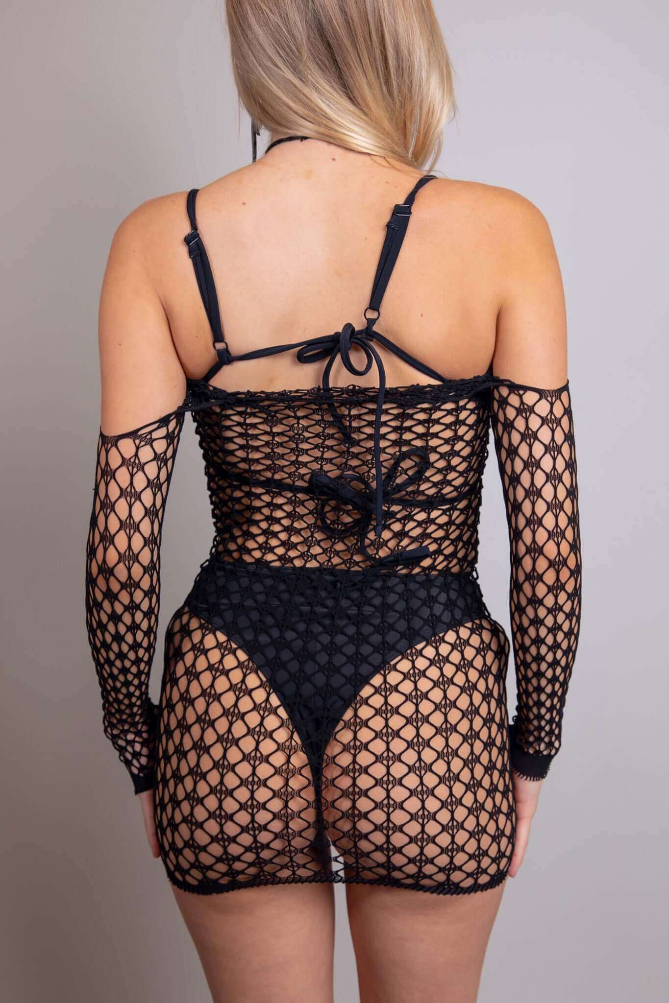 Back view of Tie It Up Halter Fishnet Dress, featuring sheer fishnet material and off-the-shoulder design, perfect for rave outfits.