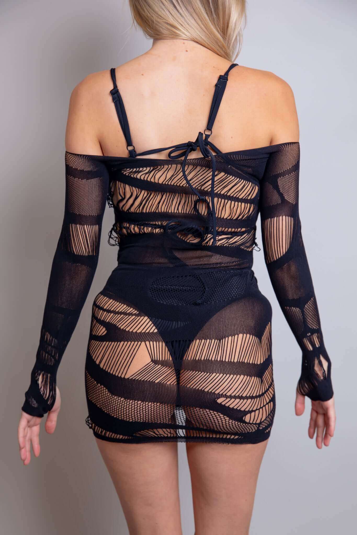 Back view of the Dark Dimensions Fishnet Dress showcasing its edgy design and off-the-shoulder style, perfect for rave outfits.