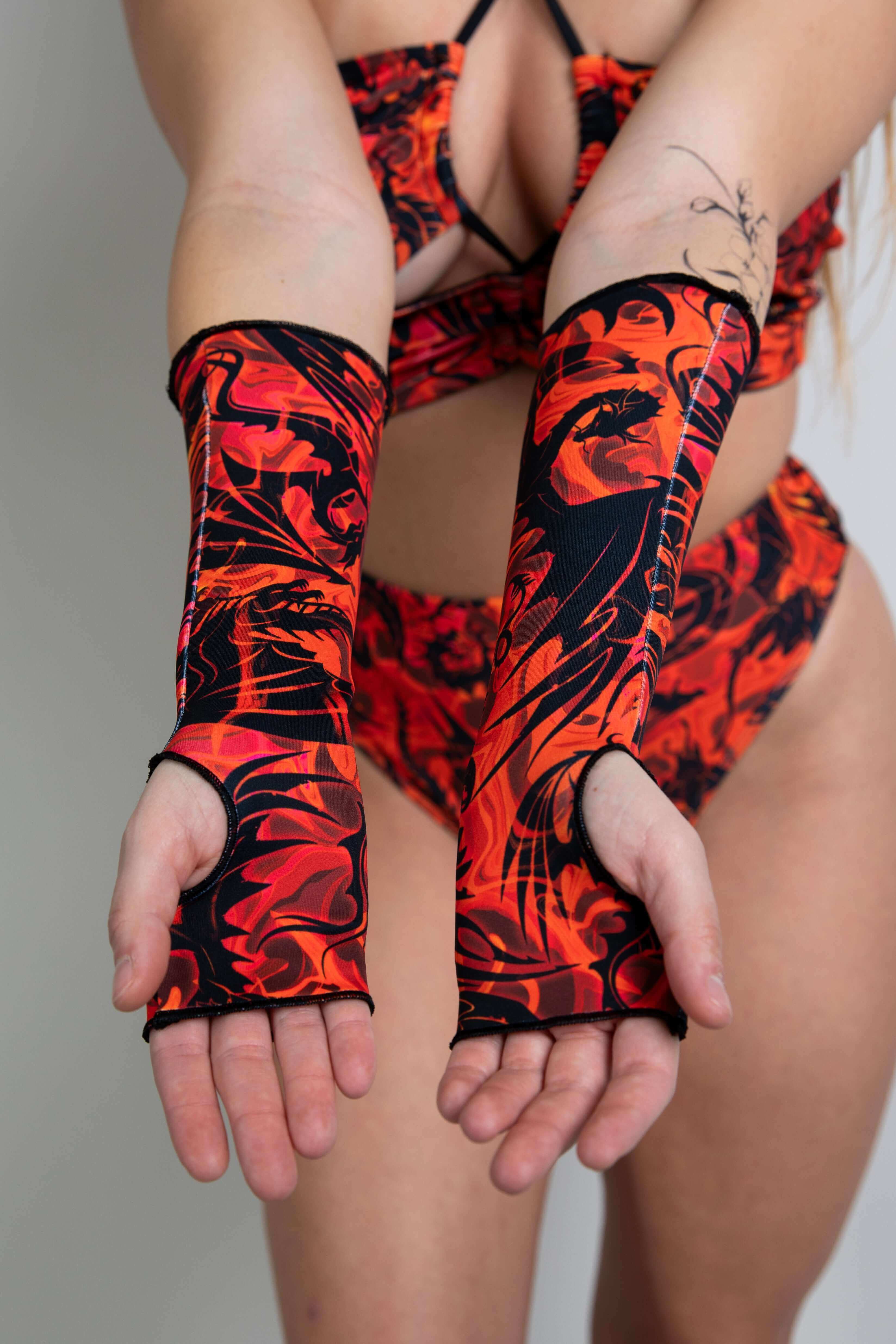 Close-up of fingerless gloves with red and orange dragon print.