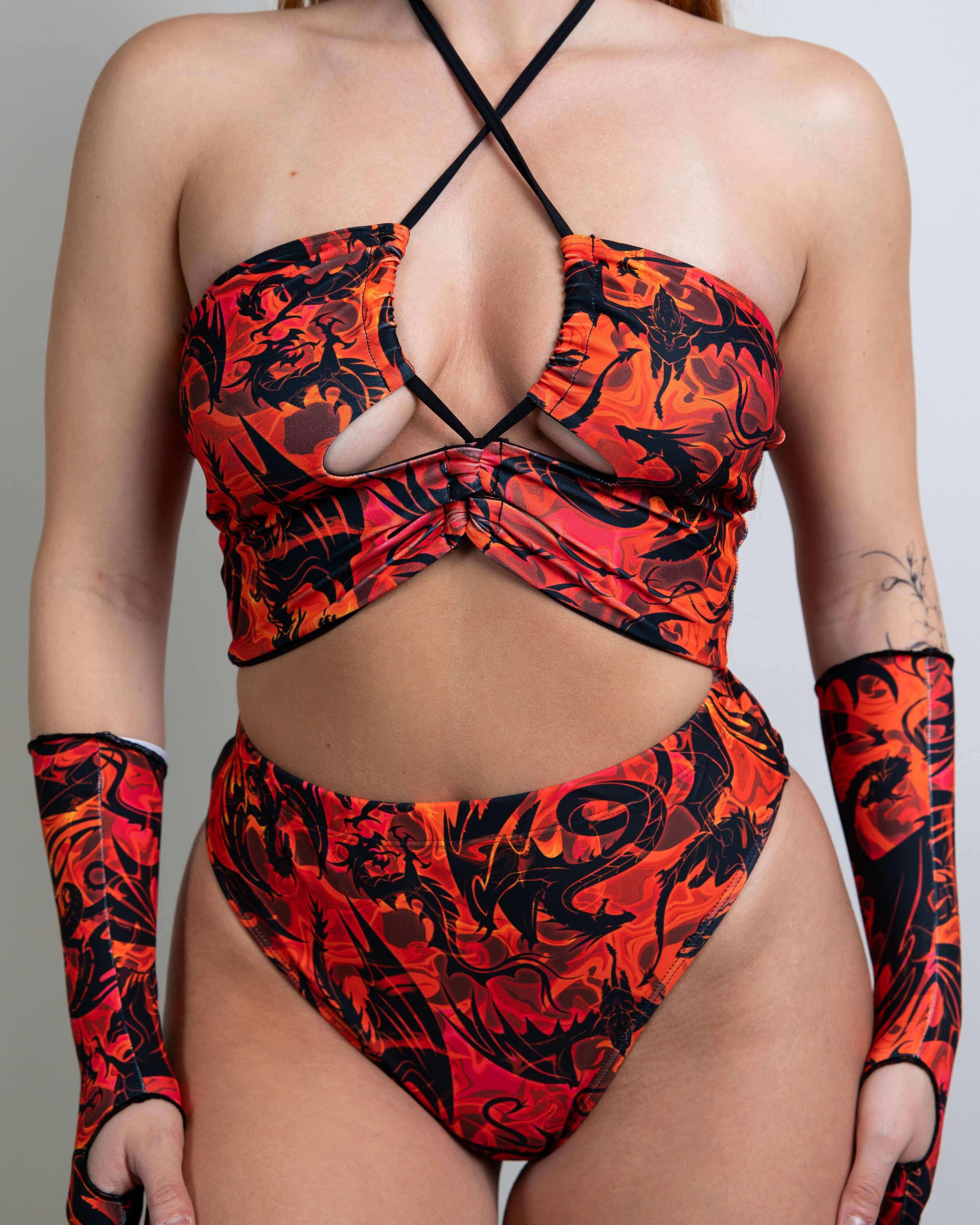 Model wearing the Forbidden Ibiza Top featuring a fiery design, perfect for rave outfits, paired with matching high-waisted bottoms.