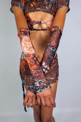 Model showcasing Fossil Arm Sleeves, complementing a rave outfit with vibrant colors and unique design.