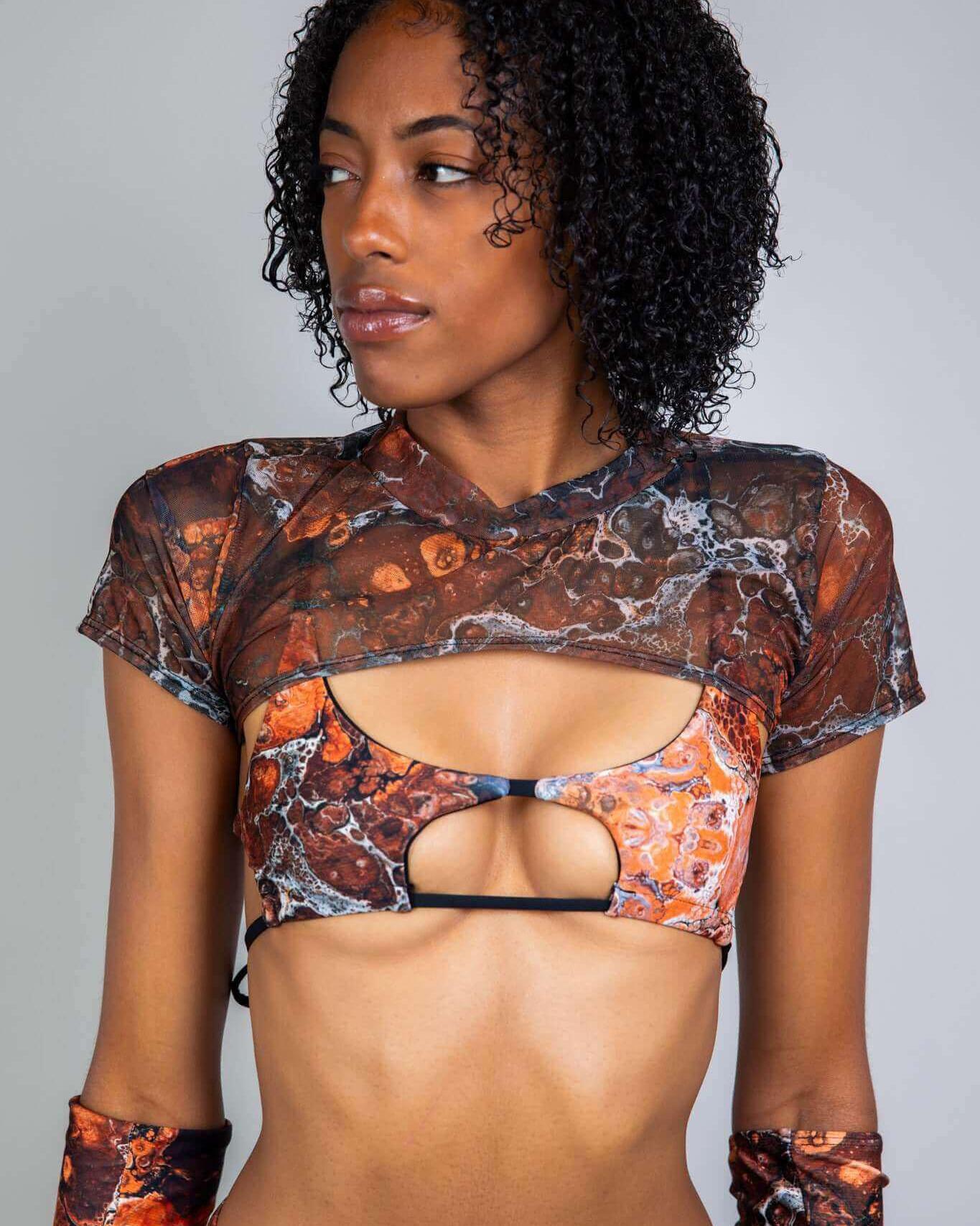 Model wearing the Fossil Mesh Strobe Top, featuring a marbled mesh design, perfect for rave outfits and confident style.