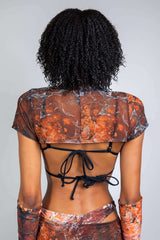 Back view of a model in a marbled mesh crop top, showcasing its unique design, perfect for rave outfits.