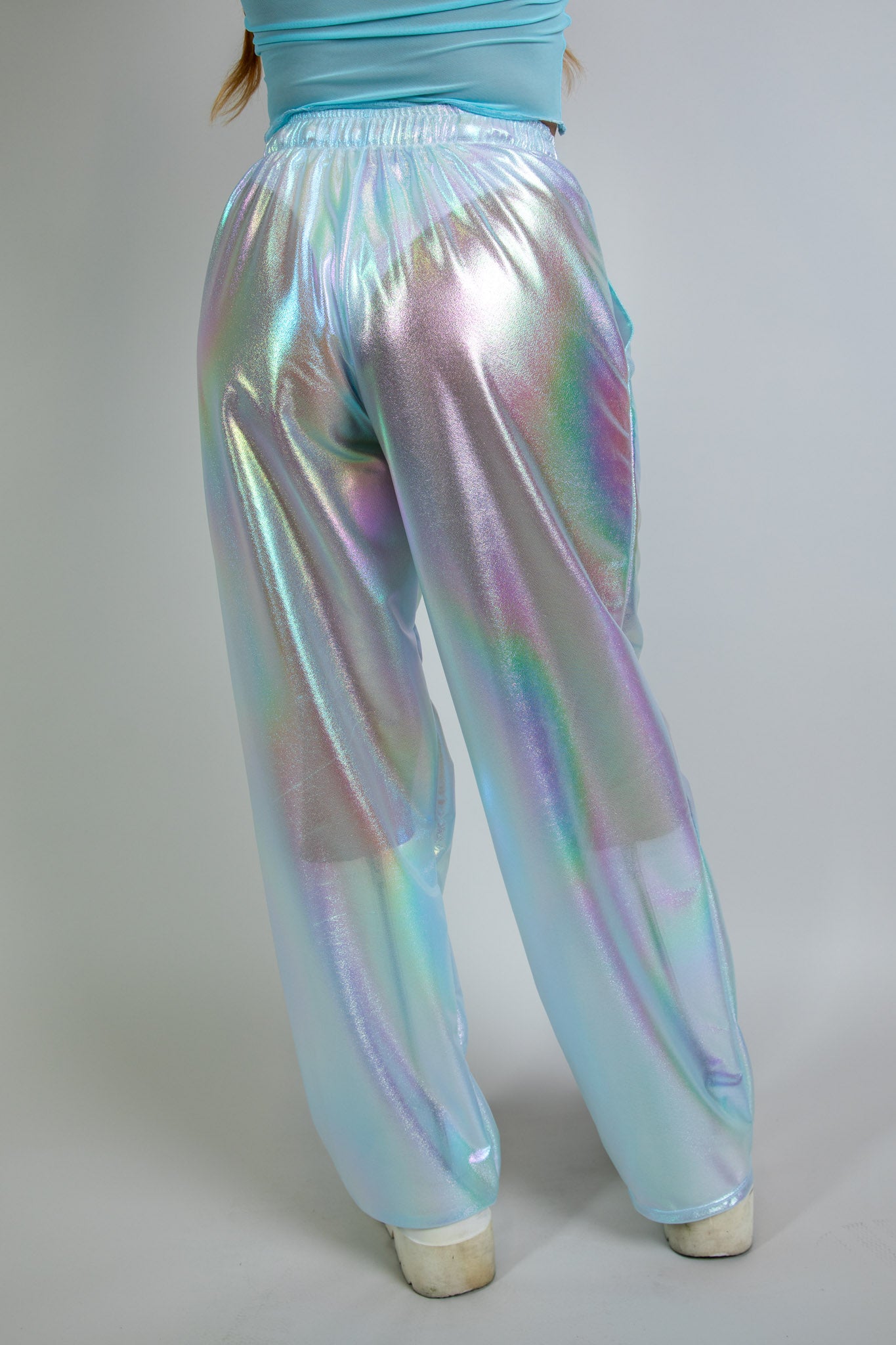 Frost Lucy Pants in iridescent blue, back view, high-waisted design with relaxed fit and shimmering fabric, perfect for festival fashion..